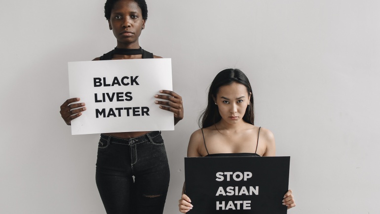 People holding signs: Black Lives Matter and Stop Asian Hate